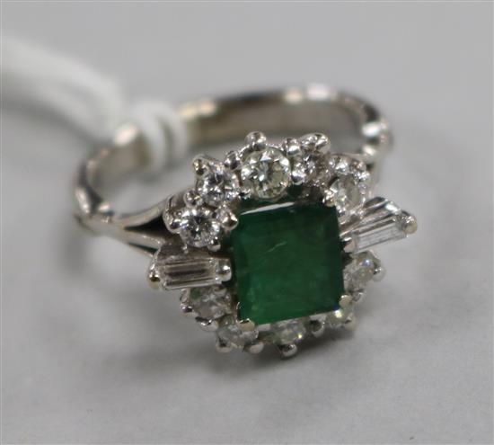 A white metal, emerald and diamond cluster dress ring, size M.